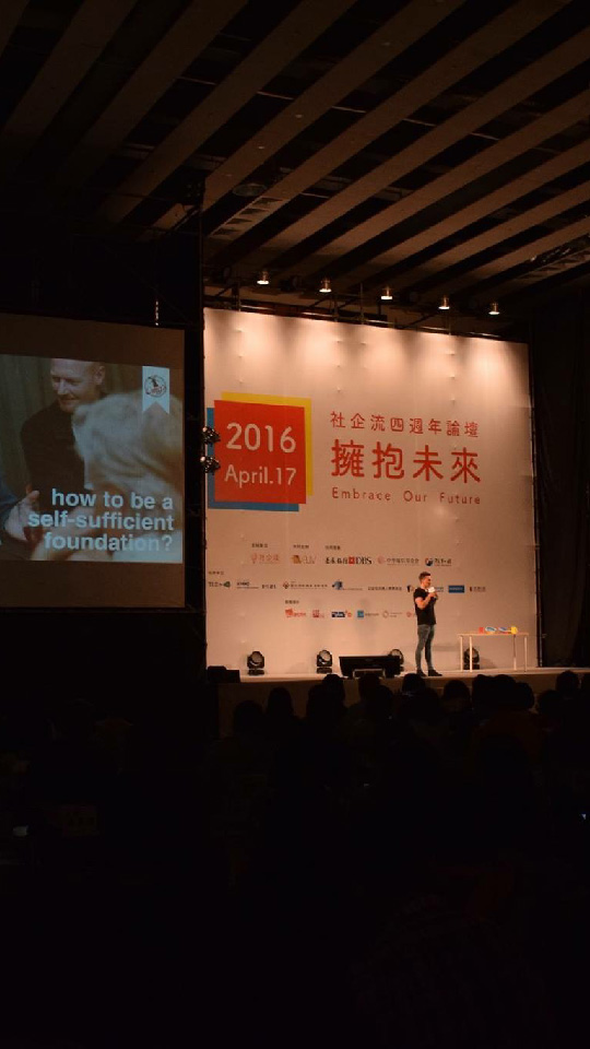 Mark Hendriks speaking on stage at a social enterprise forum in Taipei, Taiwan